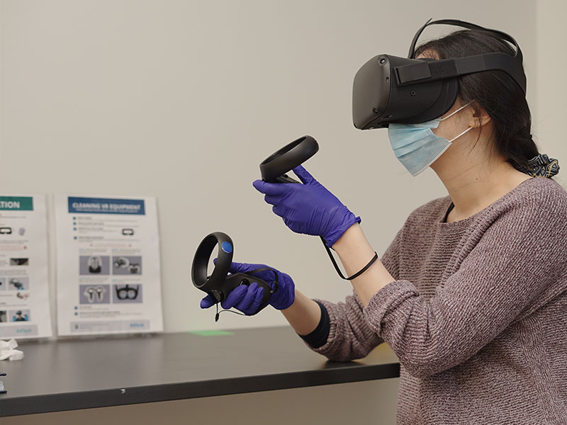 Woman with VR goggles and controllers